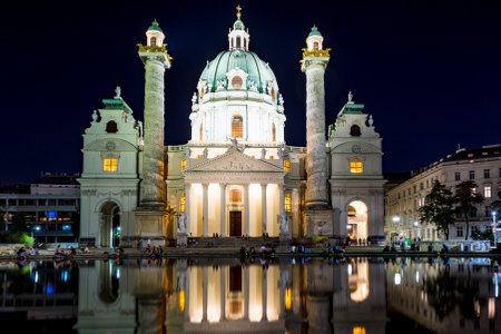 VIENNA, AUSTRIA - AUGUST 30: Tourists at the illuminated Baroque Karlskirche in Vienna, Austria on August 30, 2017. The church is considered the most outstanding baroque church in Vienna.のeditorial素材