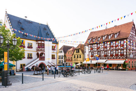VOLKACH, GERMANY - August 20: Tourists at the historic old town of Volkach, Germany on August 20,...