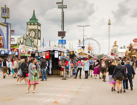 MUNICH, GERMANY - SEPTEMBER 19: People in front of the beer tents on the Oktoberfest in Munich, Germany on September 19, 2017. The Oktoberfest is the biggest beer festival of the world with over 6 million visitors each year. Foto taken from Theresienwieseのeditorial素材