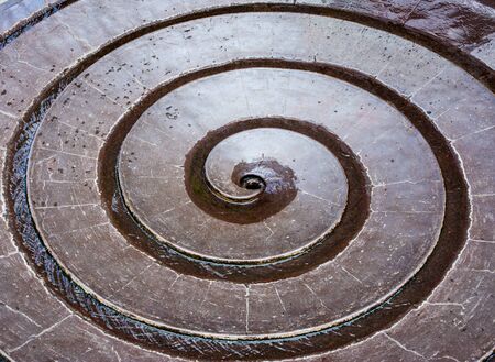 Closeup of water flowing in a sprial fountainの写真素材