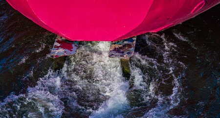 Stern wave of a pink moving vessel