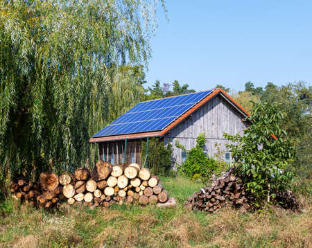 Green energy with solar collectors on the roof of an agricultural buildingの写真素材