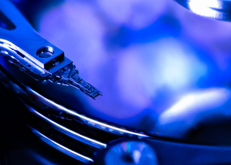 Macro of an open computer hard drive with the read/write head