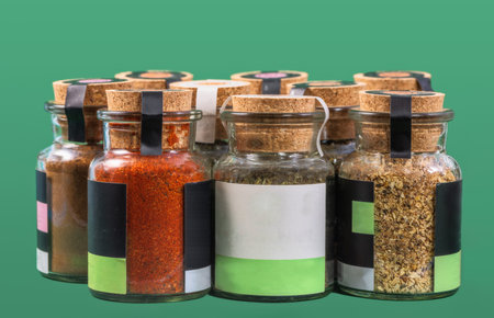 Closeup of various spices in a glass bottle