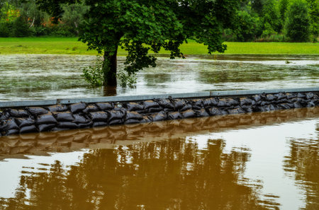 Flood protection with sandbags at a flooded streetの写真素材