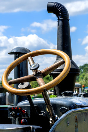 Steering wheel and exhaust pipe of an old timer tractorの写真素材