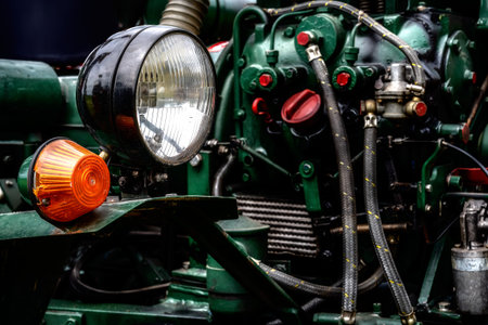 Detail of an old historic tractor old-timer motor and the headlamp