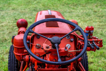 Steering wheel of an red old timer tractorの写真素材