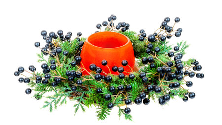 Closeup of an isolated orange vase with christmas decoの写真素材