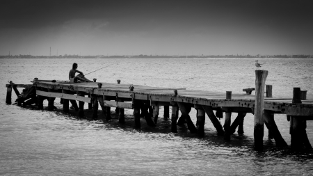 boat bridge and fhisherman fishing on Cancun beachの写真素材