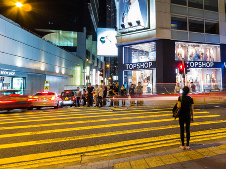 People waiting to cross a busy street in Hong Kong  Hong Kong is one of the most densely populated areas in the world  のeditorial素材