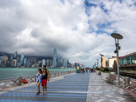 A couple walking along the Tsim Sha Tsui Promenade  Avenue of the Stars  in Hong Kong  The Avenue of...