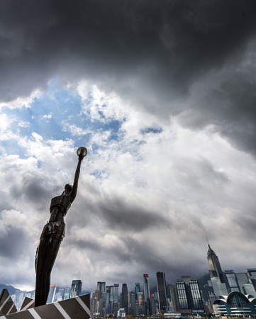 Statue and skyline in Avenue of Stars just before a tropical cyclone  Typhoons regularly skirt the city in Summer, causing heavy damages including injuries and deaths のeditorial素材