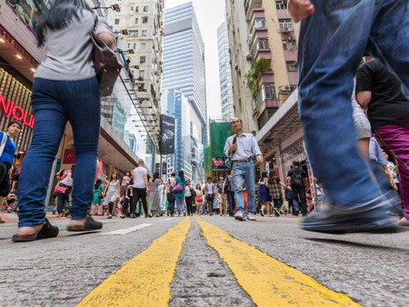 People walking through busy streets close to Times Square in Causeway Bay in Hong Kong  With 7M population, it is one of the most dense areas in the world  のeditorial素材