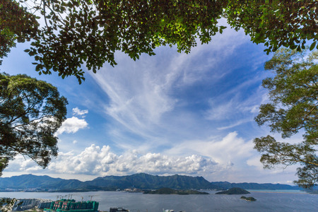 Beautiful Summer Day in Tolo Harbor Area next to the Chinese University of Hong Kong  Tsz Shan Monastery is located on these mountains の写真素材
