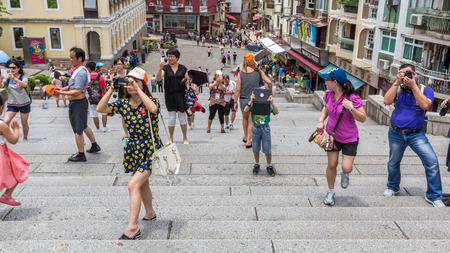 Unknown group of people taking photos of Macau church of St Paul in Macau, China  Most of the people use their mobile phones to take photos while traveling のeditorial素材