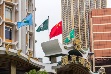 Chinese and Macau flags are raised on Hotel Lisboa in Macau  Macao, is one of the two Special Administrative Regions of the People s Republic of China のeditorial素材