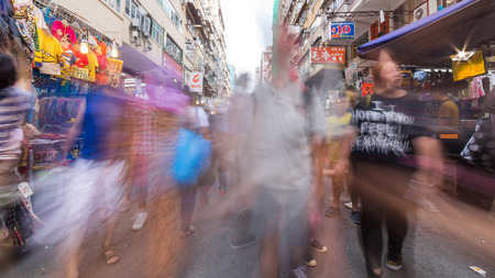 Fast moving people in Mong Kok shopping streets in Hong Kong. The flea market in Mong kok district is the most famous flea market in Hong Kong and attract many tourists. のeditorial素材