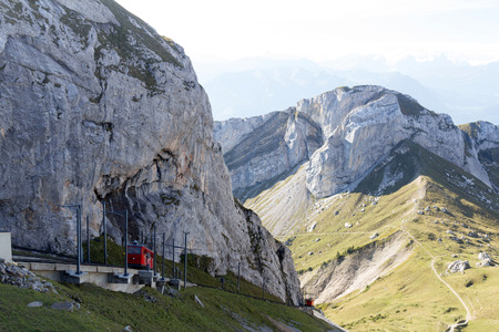 The Pilatus train, the world\'s steepest cogwheel railway nears the top of Mount Pilatus as it emerges from the clouds.の写真素材