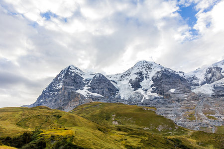 View of Eiger, Monch and Jungfrau massif from Kleine Scheidegg railway station on Swiss Alps,...