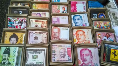 Male wallets with designs of different currency notes and famous figures for sale in Mong Kong Ladies Market in Hong Kong.のeditorial素材