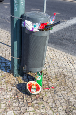 A garbage bin full of garbage found in a roadside of Lisbon the capital of Portugal.のeditorial素材