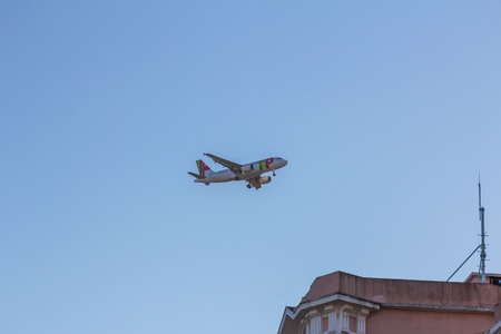 TAP Portugal flight flying over Lisbon sky. It is the flag carrier airline of Portugal headquartered at Lisbon Portela Airport which also serves as its hub.のeditorial素材