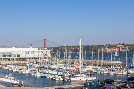Docks on the banks of River Tagus, with the bridge and Lisbon in the background, Portugalのeditorial素材