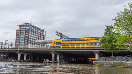 Passenger Trains NS Intercity leaving Amsterdam Central Station. Nederlandse Spoorwegen is the largest rail transport operator in NL.のeditorial素材
