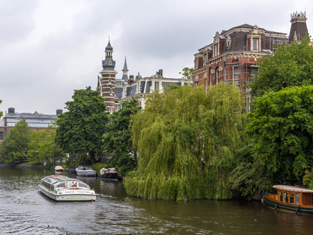 Canals through the residential areas of Amsterdam. Amsterdam is the capital and most populous city of the Netherlands.のeditorial素材