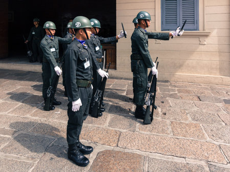 Kings Guards are marching in Grand Royal Palace in Bangkok, Thailand. Palace was the residence of...
