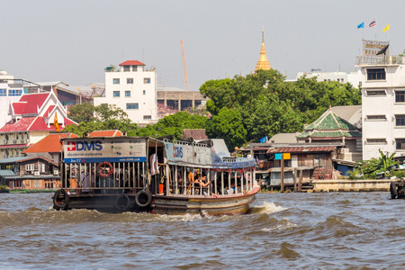 An old styled passenger boat in Chao Phraya river in Bangkok, Thailand.のeditorial素材