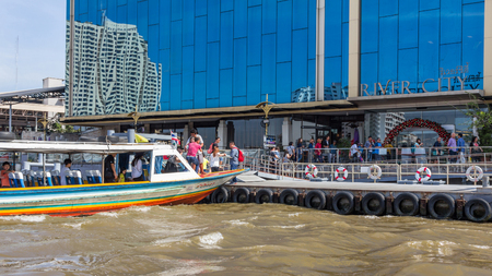 A passenger boat stopped at a pier next to River City Shopping Complex in Bangkok, Thailand. It is located alongside the Chao Phraya River on the Si Phraya Pier.のeditorial素材