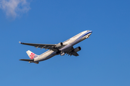 China Airlines airplane departing from the Hong Kong International Airport. About 90 airlines operate flights from HKIA to over 150 cities across the globe.のeditorial素材