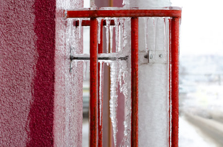 Icicles hanging on water drain pipe.