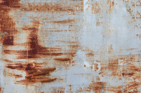 Old rusty piece of banner .Textured empty  abandoned street  advertising  panel with white peeling...