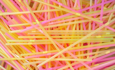 Closeup overhead  of   chaotic pile of multi colored cocktail straws.の写真素材