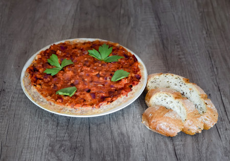 Home made baked beans  ragout  with garlic,  broth sauce,  onions, lovage and  and traditional bread...