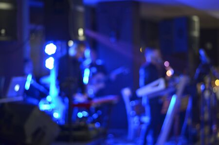 Blurred background  of  music band singing  on a stage at a concert durign night .の写真素材