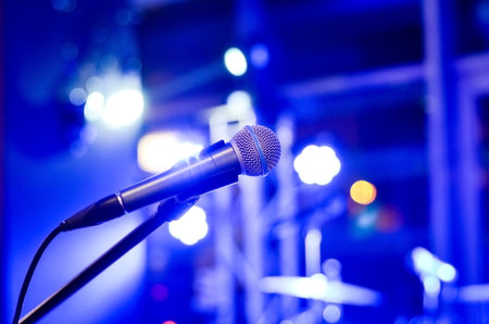 Close-up  of microphone on  empty  stage  with multi colored   blurred  background  lights    at a concert .の写真素材