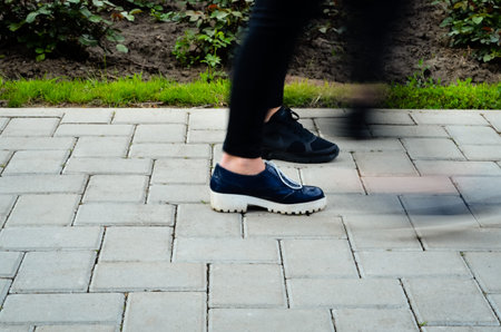 A hurried woman walking on the street - Motion Bluer effectの写真素材
