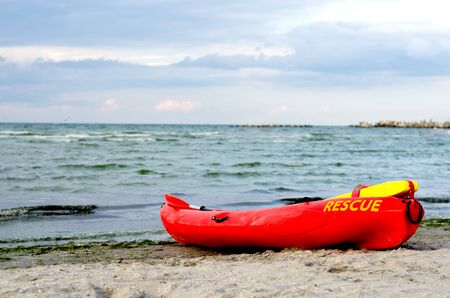 Resque  red  lifeguard kayak on sand beach  at the seaside .の写真素材