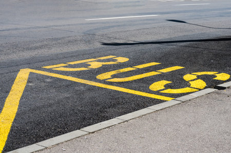 Bus stop station yellow  sign on street .