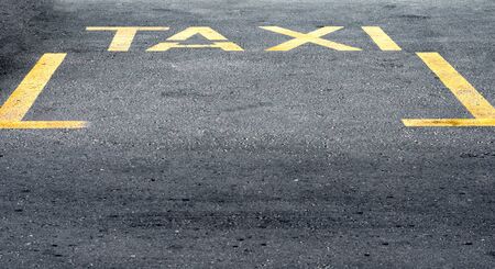 High angle view of yellow taxi sign  on road.の写真素材