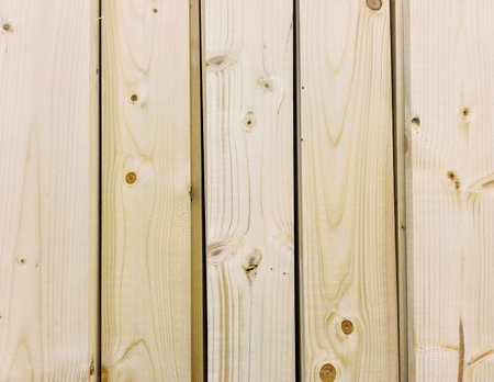 stack of wood planks for construction in warehouse 