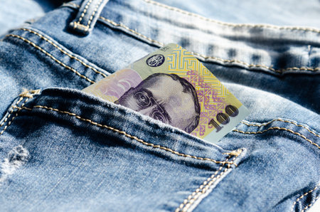 Close-up of 100  lei- ron    on the  back pocket jeans  .