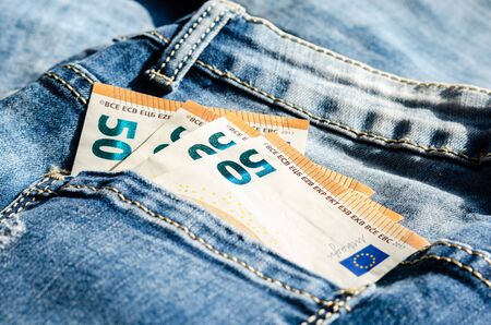  Concept regarding savings and expenses  .50 euros  in the back pocket of the pants .の写真素材