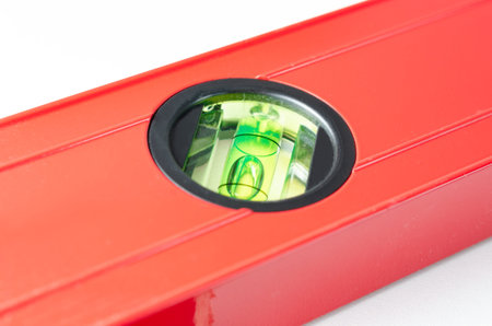 Close-up   angle  view of   red   Spirit Levels  used in construction on white  background  .