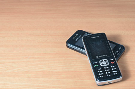 Romania -April 14,2020  : Close-up of used old damaged Samsung  GT-S5230 and V odafone mobile  phone...