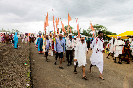 maharashtrian people walking the pilgrimage and dancing and singing devotional songs